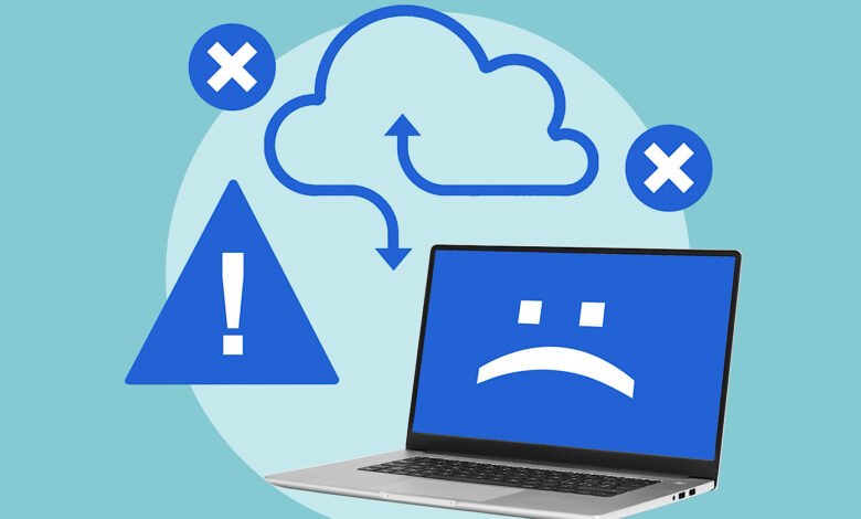 Laptop displaying a sad face icon, with error symbols and a cloud graphic indicating a system failure.