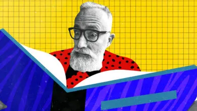 Man with glasses and beard reading a book with a vibrant yellow grid background.