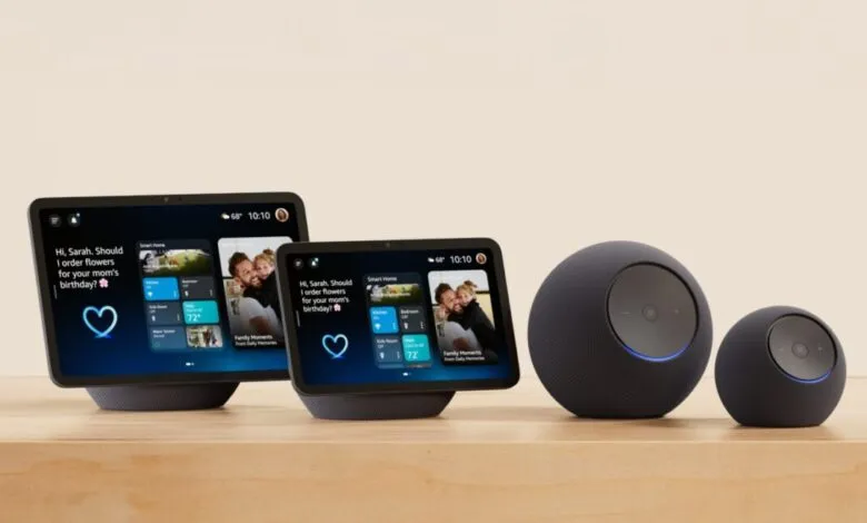 Smart home devices including two smart displays and two smart speakers on a wooden surface.