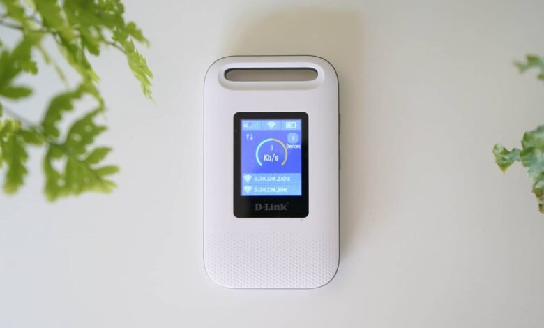 White D-Link mobile hotspot device displaying network status on its screen.