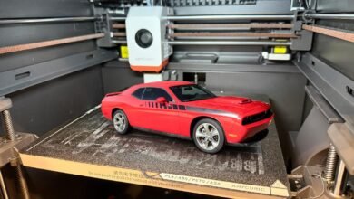 Red Dodge Challenger model car on a 3D printer bed