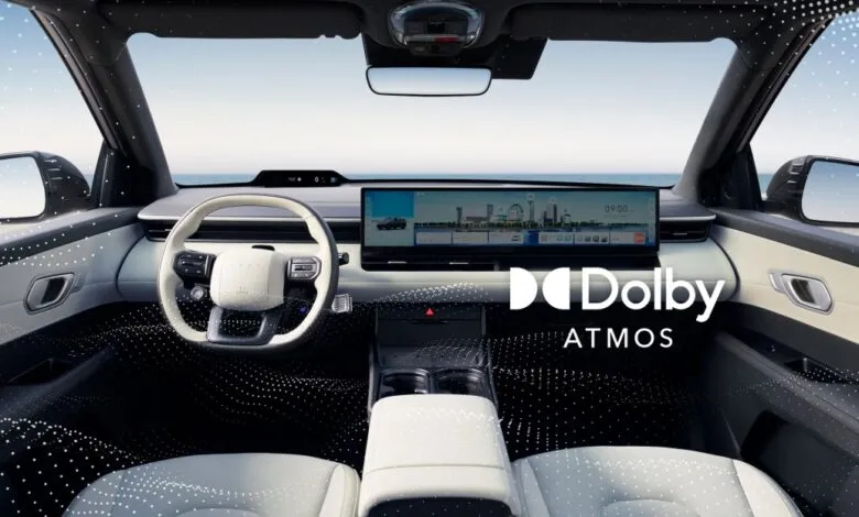 Interior view of a modern car with a large touchscreen and Dolby Atmos logo.