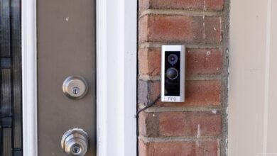 Ring Video Doorbell Pro mounted on a brick wall next to a front door.
