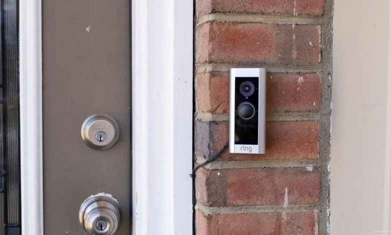 Ring Video Doorbell Pro mounted on a brick wall next to a front door.