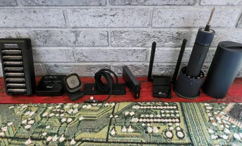 Collection of electronic gadgets including a battery charger, Wi-Fi router, and electric screwdriver.