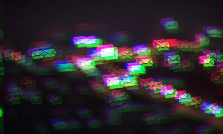 Abstract bokeh lights shaped like envelopes in vibrant neon colors.