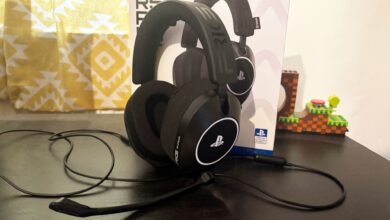Black PlayStation gaming headset with microphone on a dark surface.
