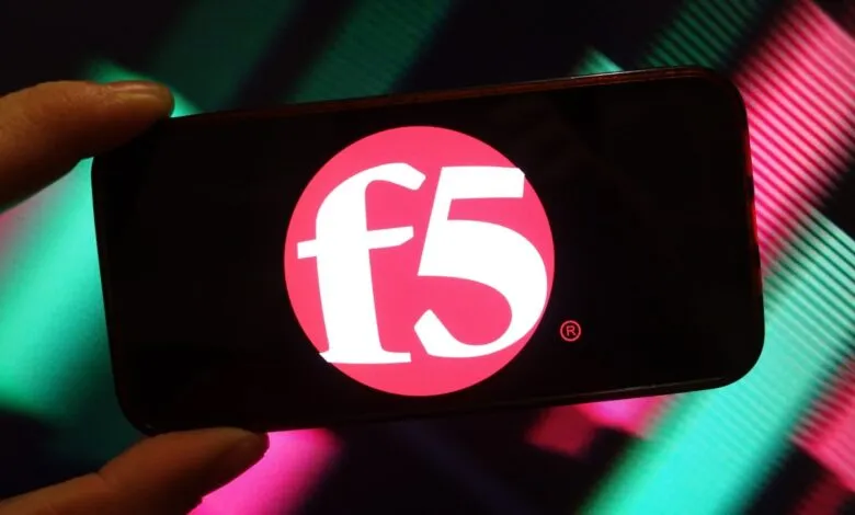 Close-up of a smartphone displaying the F5 Networks logo in bright pink.