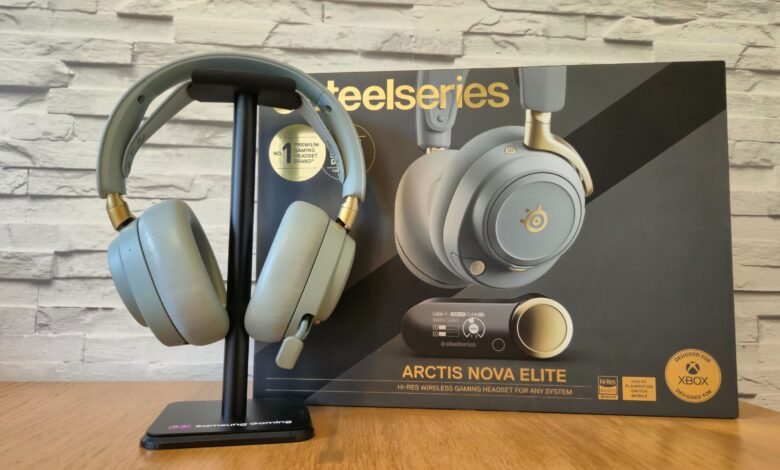 SteelSeries Arctis Nova Elite gaming headset on a stand with its box.