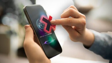 Person's finger tapping a red 'X' over a chatbot icon on a smartphone screen.