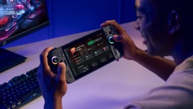 Person playing Hollow Knight: Silksong on a handheld gaming device with RGB lighting.