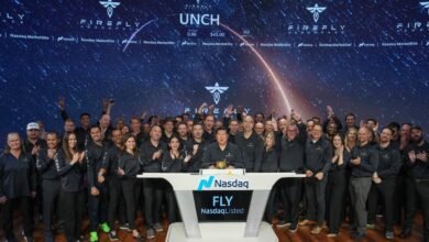 Firefly Aerospace team celebrates at Nasdaq MarketSite with a starry background.