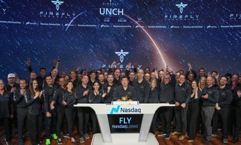 Firefly Aerospace team celebrates at Nasdaq MarketSite with a starry background.