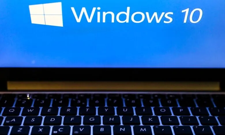 Close-up of a laptop keyboard with the Windows 10 logo and text displayed on the screen.