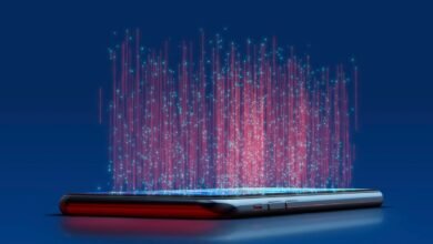 Smartphone emitting streams of red and blue digital data into the air.