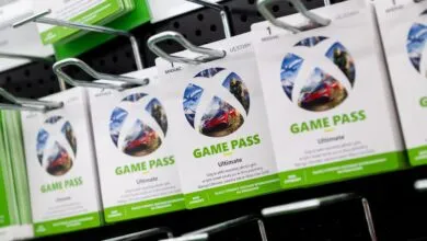 Xbox Game Pass Ultimate subscription cards displayed on a retail shelf.