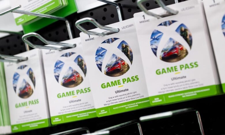 Xbox Game Pass Ultimate subscription cards displayed on a retail shelf.