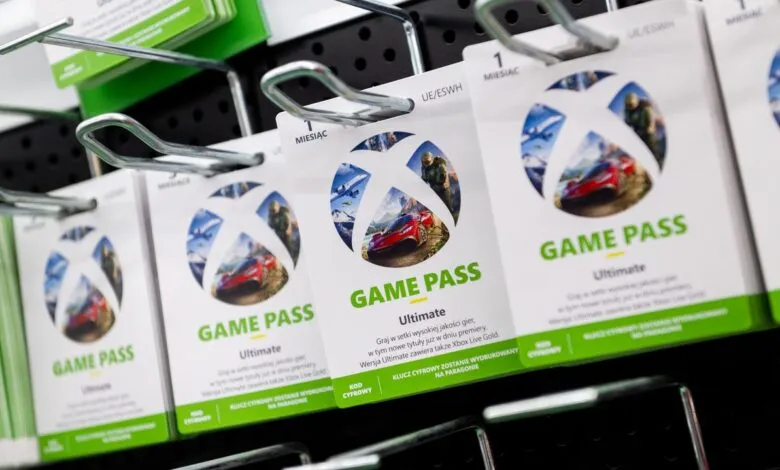 Xbox Game Pass Ultimate subscription cards displayed on a retail shelf.