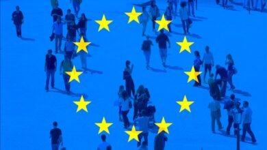 People walking across a blue background with yellow European Union stars.