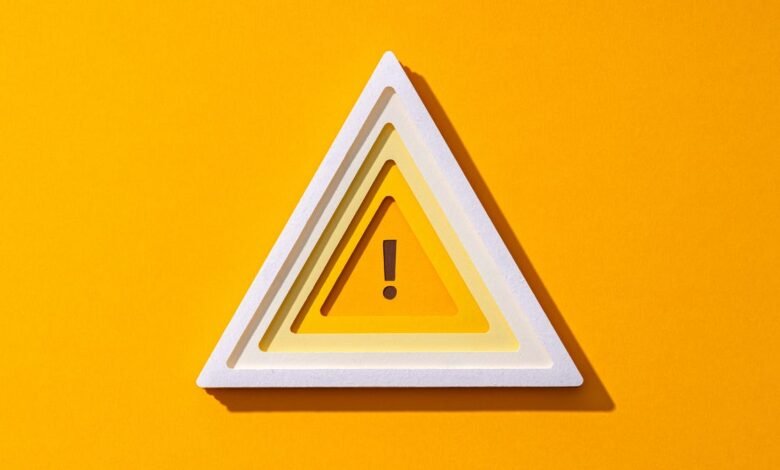 Layered warning triangle symbol with an exclamation mark on a bright yellow background.