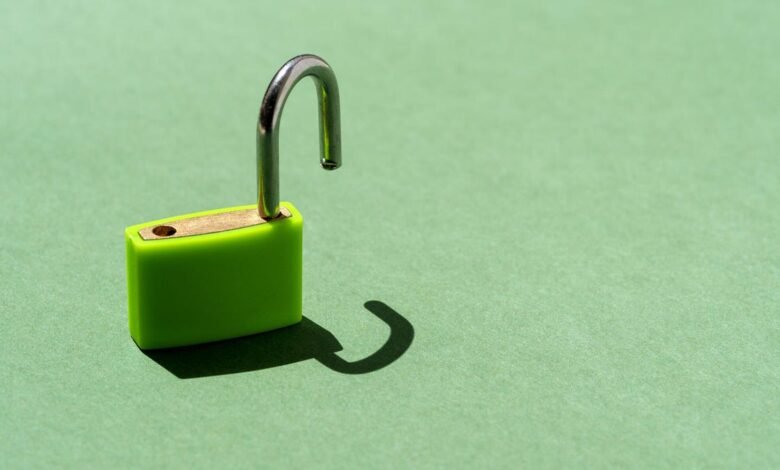 A bright green padlock is unlocked against a soft green background.