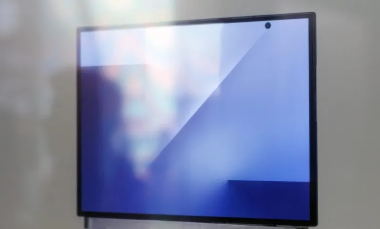 Modern flat-screen monitor displaying abstract blue graphics with light reflections.