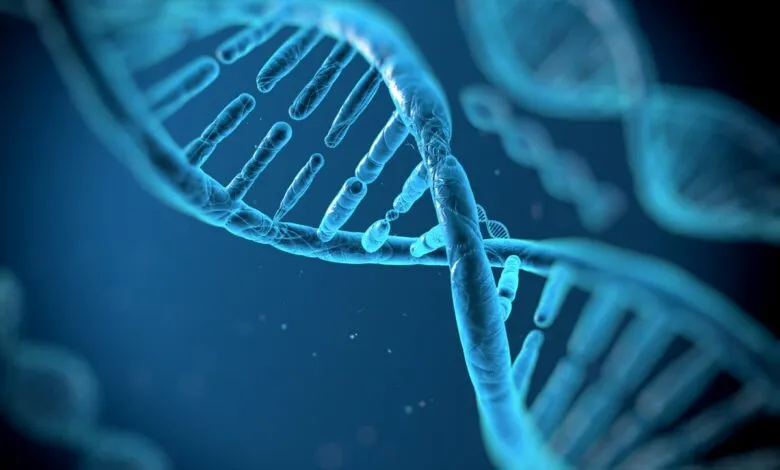 Close-up of a glowing blue DNA double helix structure against a dark background.