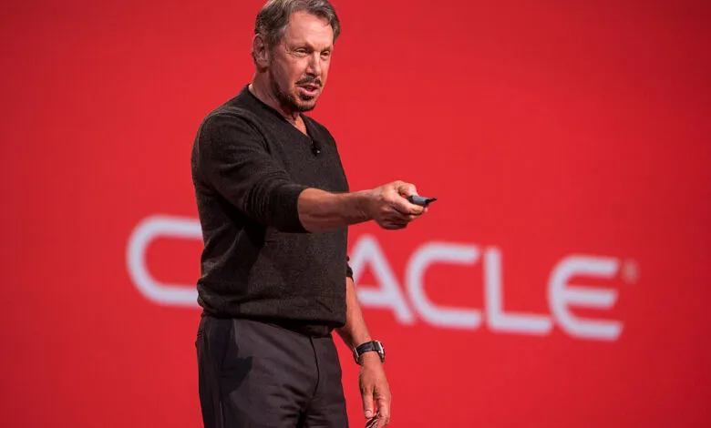 Larry Ellison speaking on stage with the Oracle logo behind him.