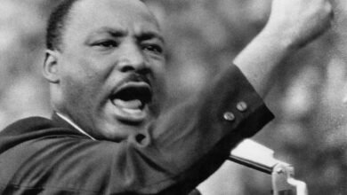 Martin Luther King Jr. speaking passionately with his fist raised.