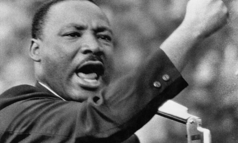 Martin Luther King Jr. speaking passionately with his fist raised.