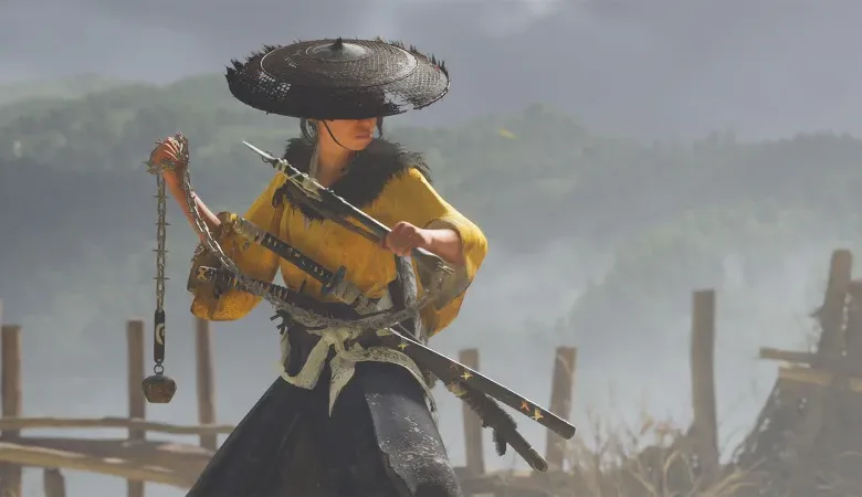 Samurai warrior in yellow robes and a conical hat holding a chain weapon and swords.