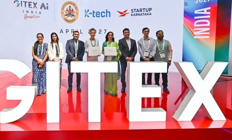 Group of people standing behind large white GITEX letters, holding certificates.