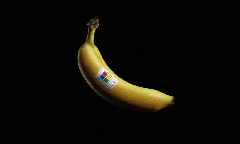 A single yellow banana with a sticker featuring the Microsoft logo and text.
