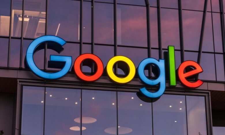 The colorful Google logo illuminated on the exterior of a modern building at sunset.