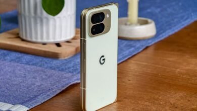 Close-up of a light green Google Pixel phone with a gold frame, showing its camera array and Google logo.