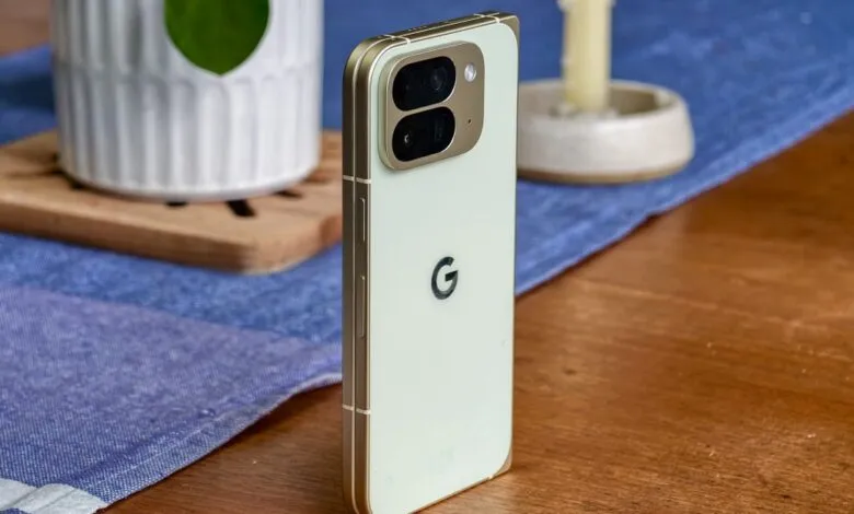 Close-up of a light green Google Pixel phone with a gold frame, showing its camera array and Google logo.