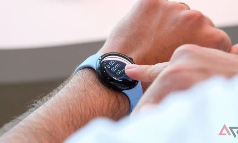 Close-up of a person's wrist wearing a Google Pixel Watch 2 with a light blue band, showing fitness stats.