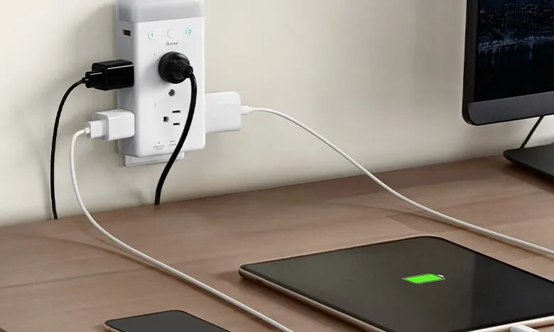 Govee smart plug with multiple devices charging on a desk.