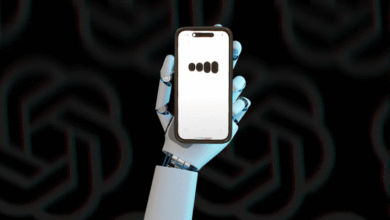 Robotic hand holding a smartphone displaying a loading or progress indicator.