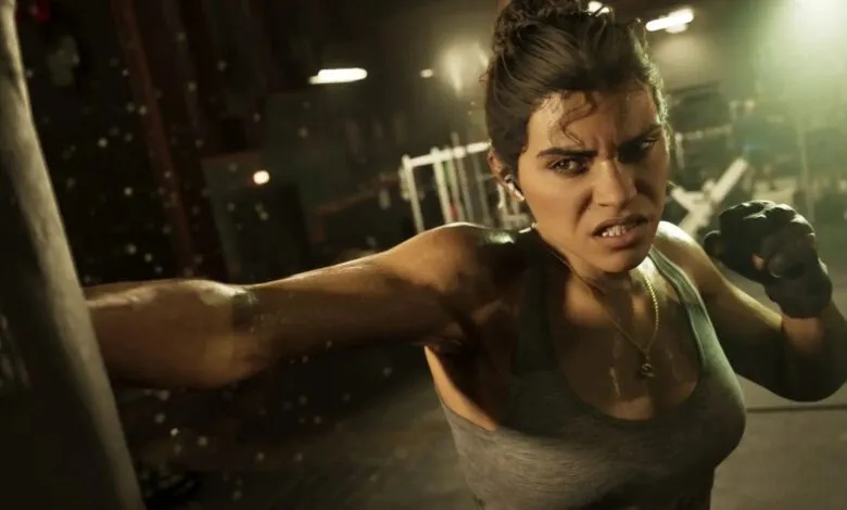 A determined woman in a gym punches a boxing bag, sweat glistening on her skin.