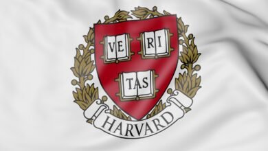 The Harvard University crest on a white, waving flag.