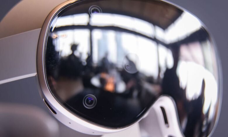 Close-up of a white virtual reality headset with multiple cameras and a reflective visor.