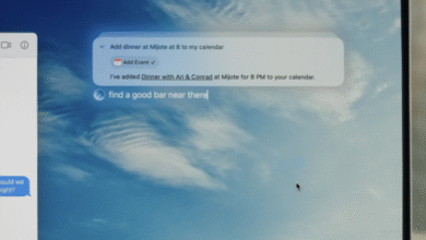 Close-up of a computer screen showing a digital assistant interface with a calendar event and a text message.