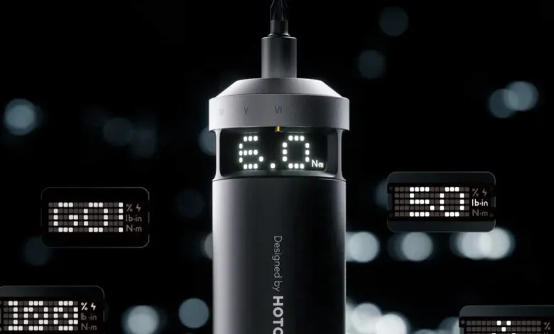 Close-up of a digital torque wrench with illuminated displays showing readings.