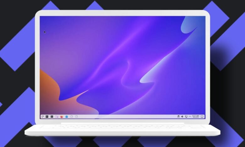 A white laptop displaying a vibrant purple and orange abstract wallpaper.