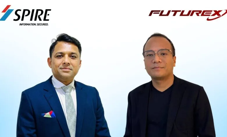 Two men in business attire stand against a gradient blue and white background with company logos.