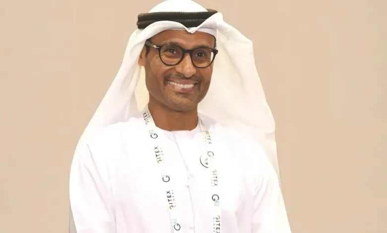 Man in traditional white thobe and ghutra wearing glasses and a GITEX Global lanyard.