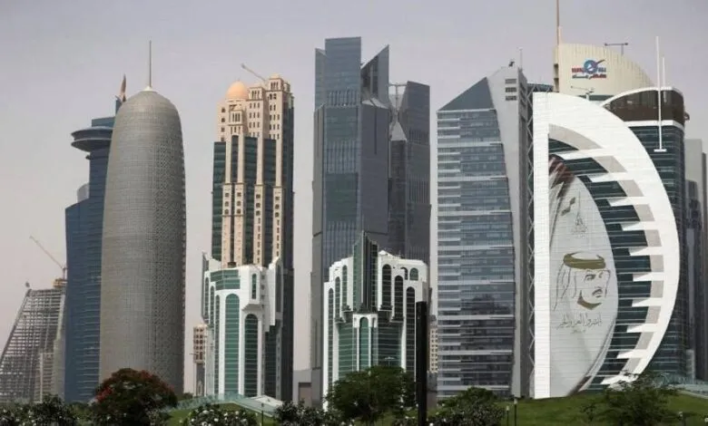 Modern skyscrapers with diverse architectural styles against a hazy sky.