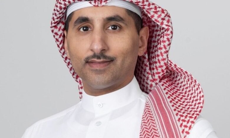 Portrait of a man wearing a white thobe and a red and white ghutra.