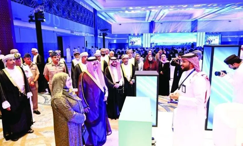 Attendees in traditional attire at a formal event with modern displays.